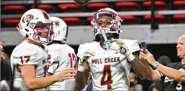  ?? HYOSUB SHIN / HYOSUB.SHIN@AJC.COM ?? Mill Creek’s Makhail Wood (4) celebrates after scoring the game-winning touchdown at Mercedes-benz Stadium. Mill Creek kept its No. 5 state ranking in Class 7A with Saturday’s 44-41 victory over Walton.