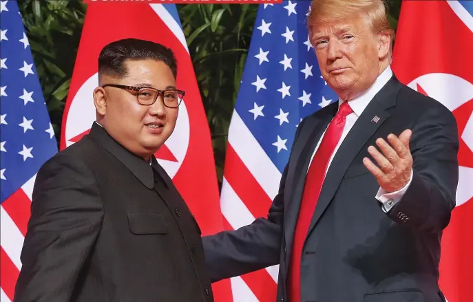  ??  ?? Making history: Kim Jong-Un and Donald Trump greet each other in front of their respective flags in Singapore yesterday before beginning their talks