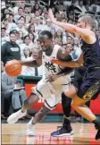  ?? Al Goldis ?? The Associated Press Michigan State guard Joshua Langford drives past Notre Dame guard Rex Pflueger in the second half of the No. 3 Spartans’ 81-63 victory Thursday.