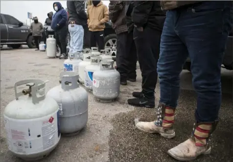  ?? Brett Coomer/Houston Chronicle via AP ?? People line up Tuesday to fill their empty propane tanks in Houston after a winter storm that brought snow, ice and plunging temperatur­es across the southern Plains and caused a power emergency in Texas. Deadly weather like this week's storm is expected to hit the U.S. more often, experts say, and government­s will have to improve their response.