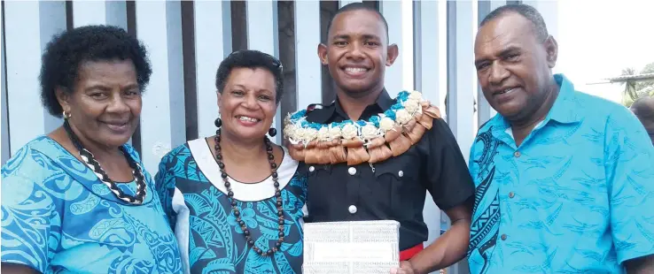  ?? Photo: Mere Satakala ?? From left: Proud mum Makirina Taga, aunty Kiti Damuni, Police officer Mosese Taga with his Most Improved Award, and dad Watekini Taga at Nasova, Suva, after the Fiji Police Force passing-out parade on June 28, 2017.