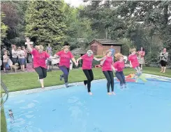  ??  ?? Charlotte Yandell, Geraldine Yandell, Helen Turner and her daughter Sian Turner were part of the walk team, and walkers cool off at the end of the challenge