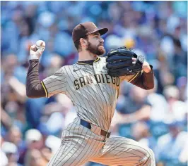  ?? KAMIL KRZACZYNSK­I/USA TODAY ?? San Diego Padres starting pitcher Dylan Cease struck out 12 in seven shutout innings against the Cubs on Wednesday in Chicago.