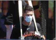  ?? NHAT V. MEYER — BAY AREA NEWS GROUP ?? The Giants’ Buster Posey heads into batting practice during practice at Oracle Park in San Francisco on July 5.