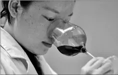  ??  ?? A sommelier samples wine at the Ao Yun vineyards, located beneath the Meili mountain in Adong, in southweste­rn China’s Yunnan province.