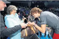  ?? CLIVE BRUNSKILL GETTY IMAGES ?? Alexander Zverev greets his parents and dog after winning. He downplayed it, noting Novak Djokovic has won five ATP Finals.