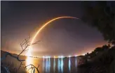  ?? The Associated Press ?? This photo shows a time exposure from the shore of the Banana River near Port Canaveral of the launch of the SpaceX Falcon 9 rocket.