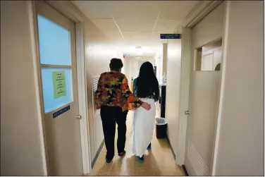  ?? (File Photo/AP/Rebecca Blackwell) ?? A 33-year-old mother of three from central Texas is escorted down the hall Oct. 9 by clinic administra­tor Kathaleen Pittman prior to getting an abortion at Hope Medical Group for Women in Shreveport, La.