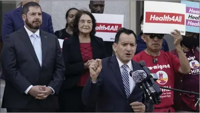  ?? RICH PEDRONCELL­I THE ASSOCIATED PRESS ?? California Assembly Speaker Anthony Rendon, D-Lakewood, center, speaks in support of health care for all low-income immigrants living in the country illegally during a rally at the Capitol in Sacramento on Wednesday.