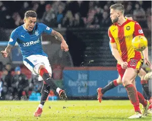  ?? Picture: SNS. ?? James Tavernier sends a dipping shot into the Thistle net for Rangers’ second goal.