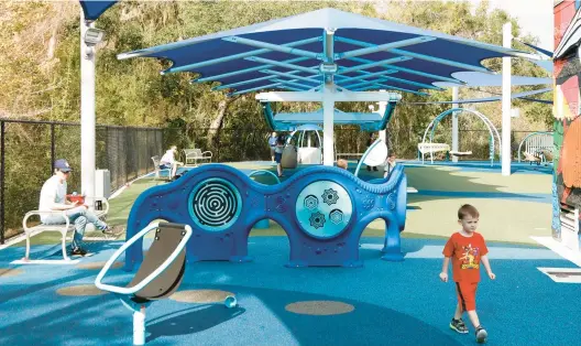  ?? JEFFEREE WOO/TAMPA BAY TIMES PHOTOS 2022 ?? Families enjoy the new All Abilities Playground that recently opened at the New Tampa Recreation­al Center in Tampa, Florida.