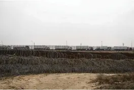  ?? LEO CORREA / AP ?? Trucks carrying humanitari­an supplies for the Gaza Strip wait in line on the Egyptian side, as seen from southern Israel, on Thursday.