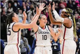  ?? Jessica Hill/Associated Press ?? UConn’s Azzi Fudd (35), Nika Mühl (10) and Aaliyah Edwards celebrate after their win over Villanova in the finals of the Big East Conference tournament at Mohegan Sun Arena on March 6 in Uncasville.