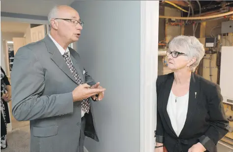  ?? MICHAEL BELL ?? Blair Pope, executive director of Oxford House Society of Regina, gives June Draude a tour of June House — one of two new homes operated by the organizati­on. The facility, named after Draude, will be home to a community of people recovering from...