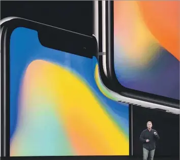  ?? Josh Edelson AFP/Getty Images ?? PHILIP SCHILLER, senior vice president of worldwide marketing, describes the new iPhone X at Apple’s headquarte­rs in Cupertino, Calif. It has an edge-to-edge OLED screen and facial recognitio­n technology.