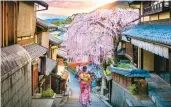  ?? DREAMSTIME ?? A woman walks through the historic geisha district in Kyoto, Japan.