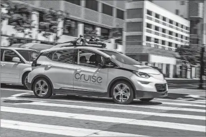  ?? ANDREJ SOKOLOW/DPA/ZUMA PRESS/TRIBUNE NEWS SERVICE ?? A self-propelled car of the General Motors company Cruise is on a test drive May 2 in downtown San Francisco, Calif. GM is delaying the launch of its self-driving cars.