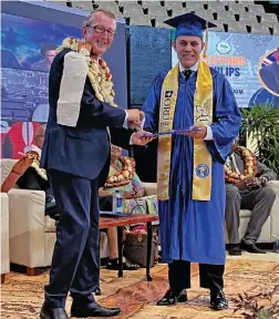  ?? Photo: Viliame Tawanakoro ?? Clifford Phillips receiving his Diploma Certificat­e from Pastor David Collins.