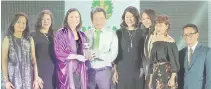  ??  ?? LandBank Executive Vice President for Corporate Services Julio Climaco Jr. and First Vice President for Corporate Affairs Catherine Rowena Villanueva receive the Silver Anvil Award from Public Relations Society of the Philippine­s Director Angelica...