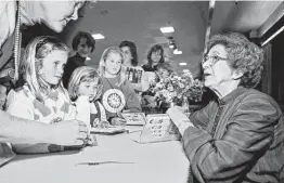  ?? Associated Press file photo ?? Beverly Cleary signs books at the Monterey Bay Book Festival in Monterey, Calif., in 1998. The beloved children’s author died Thursday. She was 104.