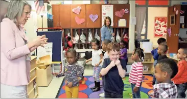  ?? Spencer Lahr / RN-T ?? South Rome Early Learning Center teacher Cayce Jacobson asks students to make an angry face while singing a song about squirrels before lunch Thursday, while SRELC director Teri Oberg watches from the back.