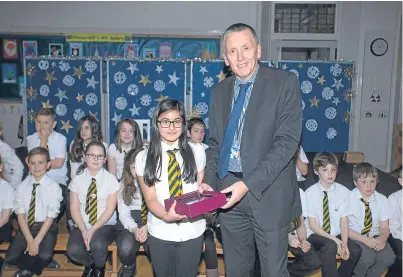  ??  ?? Fife Council’s education head Peter McNaughton, pictured with Pittencrie­ff Primary School pupils.