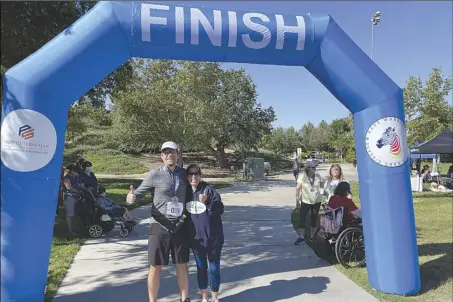  ?? Photo Courtesy of Christophe­r Velona ?? Greg Santilli and Stacey Roth pose for a photo after finishing the Rare Warrior 5 X 5 Fun Run event recently at Valencia Heritage Park.