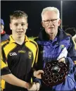  ??  ?? Owen Doyle presents Ashford captain Sam Bishop with the ‘C’ Shield.