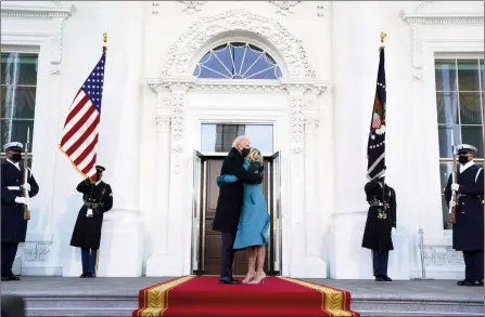  ?? The Associated Press ?? President Joe Biden hugs his wife, Jill, as they prepare to walk into the White House, Wednesday, in Washington after Biden was sworn in as the 46th president of the United States.