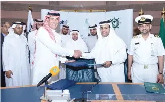  ??  ?? Bahri and King Abdulaziz University officials shake hands after signing a training agreement.