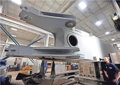  ?? RICK WOOD/MILWAUKEE JOURNAL SENTINEL ?? Ryan Becker, a machinist, checks out a large boom being machined for a large P&H electric mining shovel in March at Strohwig Industries in Richfield.