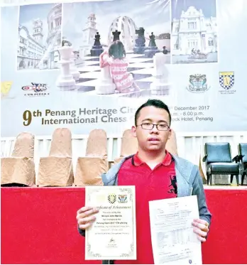  ?? CONTRIBUTE­D PHOTO ?? DAVAO’S PRIDE. John Marvin Miciano of Davao City earns his Fide master (FM) title after an impressive finish in the recently-concluded 2017 Penang Heritage City Internatio­nal Chess Open 2017 in Malaysia.