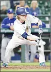  ??  ?? Seattle Mariners’ Gordon Beckham lays down a sacrifice bunt as Texas Rangers catcher Robinson Chirinos looks on in the eighth inning of a baseball game on May 15, in
Seattle. (AP)