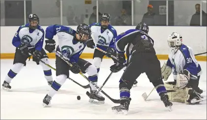  ?? STEVEN MAH/SOUTHWEST BOOSTER ?? Bantam Broncos defenseman Hendrik de Klerk (second from left) was on the spot to a clear a puck away from the crease of Jacob Herman (right).