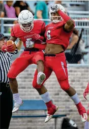  ?? GREG LOVETT / THE PALM BEACH POST ?? Oxbridge Academy’s Antavious Lane (left) celebrates his intercepti­on with Dorian Jones in a 41-0 win over Royal Palm Beach on Thursday night.