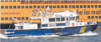  ??  ?? WET WORK:
The NYPD’s Harbor Unit escorts the Staten Island Ferry (above) and inspects the base of the Brooklyn Bridge (right). Cops on that team are called upon to dive under and look for murder weapons.