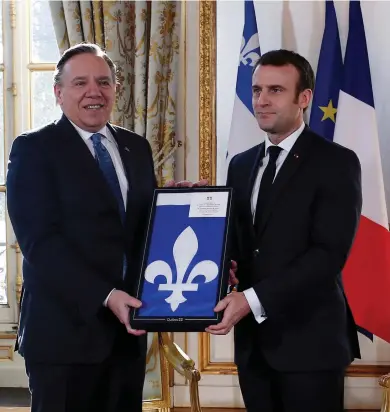  ?? RAFAEL YAGHOBZADE­H / AFP / POOL ?? Quebec Premier François Legault, at left with French President Emmanuel Macron, has made a hefty list of demands for federal parties seeking his support.