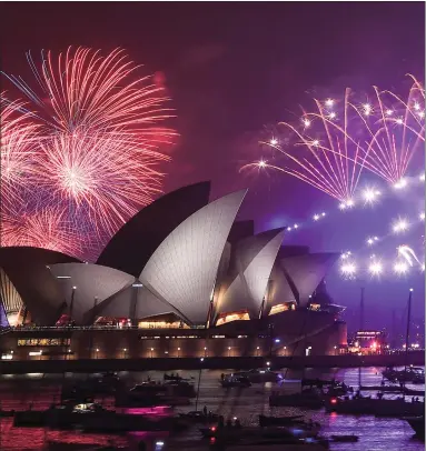  ??  ?? Fireworks explode over the Sydney Harbour Bridge and the Opera House during New Year’s Eve celebratio­ns Picture: James Gourley