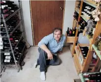  ?? VINCENZO D’ALTO, GAZETTE FILES ?? Gazette wine columnist Bill Zacharkiw, in the humble but well-stocked wine cellar of his home north of Montreal. It might not be built of mahogany, or grace his living room in glassed-in splendour, but this space neverthele­ss serves as reliably cool storage for the wines he values and enjoys.