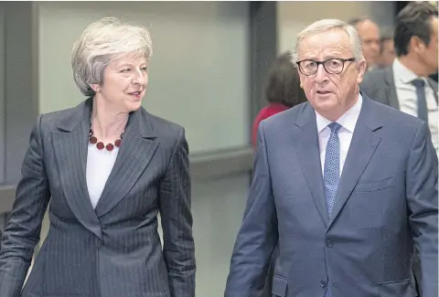  ?? BLOOMBERG ?? Theresa May, UK prime minister, left, and Jean-Claude Juncker, president of the European Commission, arrive ahead of negotiatio­ns in Brussels on Wednesday.