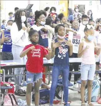  ?? Brodie Johnson • Times-Herald ?? The Rolling Readers at the Forrest City School District’s Freedom School program made their way to Central Elementary School this morning to promote literacy in the schools. Students this morning heard a story from Forrest City School Board member Annie Norman, followed by a dance routine as they prepared for the day.