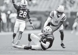  ?? DAVID SANTIAGO dsantiago@miamiheral­d.com ?? UM safety James Williams intercepts a pass intended for Central Connecticu­t State wide receiver Tyshaun James during the third quarter at Hard Rock Stadium on Saturday.