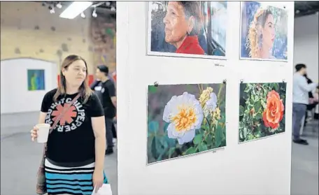  ?? Photograph­s by Gary Coronado Los Angeles Times ?? AN EXHIBIT at Self Help Graphics &amp; Art draws visitors in contested area of Boyle Heights known as Flats that is popular with galleries.