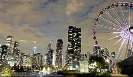  ?? MELISSA KOSSLER DUTTON — THE NEWS-HERALD ?? The Ferris wheel was invented in Chicago, and amazing skyline views are part of the experience on the Centennial Wheel, installed with heated cars last year to celebrate Navy Pier’s 100th anniversar­y.