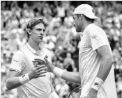  ?? GLYN KIRK/ASSOCIATED PRESS ?? Kevin Anderson, left, greets John Isner after defeating him in a grueling singles semifinal match Friday at Wimbledon.