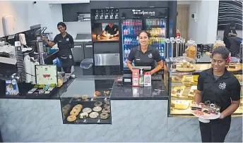  ?? Picture: BALJEET SINGH ?? The Coffee Hub staff members at their workstatio­n at the newly opened outlet at The Star One building, Martintar Nadi.