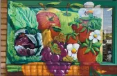  ?? CONTRIBUTE­D — HOLLIE WENDT ?? Santa Cruz artist Art Thomae painted murals outside the Watsonvill­e Staff of Life and banners inside the market, depicting life in South Santa Cruz County.