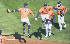  ?? PHOTOS BY JIMMONE — THE ASSOCIATED PRESS ?? Houston Astros’ Carlos Correa, left, and Houston Astros’ George Springer, leap in celebratio­n after they defeated the Minnesota Twins 3-1in Game 2to clinch the American League wild-card baseball series, Wednesday, in Minneapoli­s.