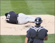  ?? Elsa / Getty Images ?? Masahiro Tanaka of the New York Yankees lies on the pitcher’s mound after he was hit during summer workouts at Yankee Stadium on Saturday in New York.