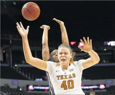  ?? SUE OGROCKI / ASSOCIATED PRESS ?? UT’s Kelsey Lang loses the ball when a West Virginia player fouls her Sunday in a Big 12 semifinal. The Longhorns fell to 2-4 since their 19-game winning streak, and coach Karen Aston says they were “out-competed.”